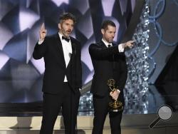 David Benioff, left, and D.B Weiss accept the award for outstanding writing for a drama series for “Game of Thrones” at the 68th Primetime Emmy Awards on Sunday, Sept. 18, 2016, at the Microsoft Theater in Los Angeles. (Photo by Chris Pizzello/Invision/AP)