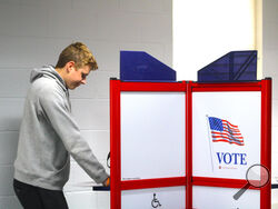 A young voter in Charlevoix County, Michigan, casts his ballot on Nov. 1, 2024. (USA TODAY Network)