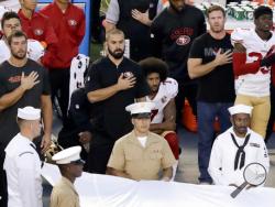 San Francisco 49ers quarterback Colin Kaepernick, middle, kneels during the national anthem before the team's NFL preseason football game against the San Diego Chargers, Thursday, Sept. 1, 2016, in San Diego. (AP Photo/Chris Carlson)