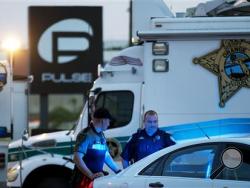 In this June 17, 2016 file photo, law enforcement officials stand outside the Pulse nightclub following Sunday's mass shooting, in Orlando, Fla. More police departments are exploring technology that would allow 911 emergency dispatchers to receive text messages from people who need help. When gunshots rang out at the Pulse nightclub in Orlando last month, patrons hid from the gunman and frantically texted relatives to call 911 because Orlando doesn't have 911 texting. (AP Photo/David Goldman, File)