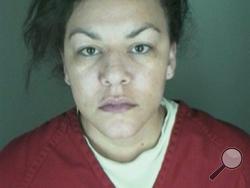 This undated booking photo provided by the Longmont Police Department shows Dynel Lane, 34, who is accused of stabbing a pregnant woman in the stomach and removing her baby, while the expectant mother visited her home to buy baby clothes advertised on Craigslist, authorities said.