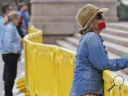 n this March 10, 2016 file photo, Sandy Springer, of Edmond, Okla., stands with other members of Bound 4 Life, an anti-abortion group, at the state Capitol in Oklahoma City. The Oklahoma House has passed legislation that requires the state Department of Health to develop informational material "for the purpose of achieving an abortion-free society," but lawmakers didn't approve any funding for it. (AP Photo/Sue Ogrocki, File)