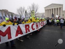 FILE - In this Jan. 22, 2016, file photo, marchers carry a banner during the March for Life 2016, in front of the U.S. Supreme Court in Washington, during the annual rally on the anniversary of 1973 'Roe v. Wade' U.S. Supreme Court decision legalizing abortion. Roe v. Wade could be in jeopardy under Donald Trump's presidency. If a reconfigured high court did overturn it, the likely outcome would be a patchwork: some states protecting abortion access, others enacting tough bans, and many struggling over what