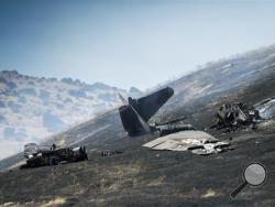 An aircraft assigned to the 1st Reconnaissance squadron at Beale Air Force Base and on a training mission went down on the lower slopes of the Sutter Buttes on Tuesday, Sept. 20, 2016 in Sutter County, Calif. The U.S. Air Force says one pilot was killed, and one was injured after they ejected from the plane. (Hector Amezcua/The Sacramento Bee via AP)