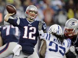 Is Tom Brady throwing an illegally deflated football in this picture? The NFL is investigating whether the team let air out of balls to make them easier to thrown and catch. (AP Photo/Charles Krupa)