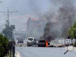 Fire and smoke rise at the site of a suicide attack during clashes with Taliban fighters in front of the Parliament, in Kabul, Afghanistan, Monday, June 22, 2015. (AP Photo/Massoud Hossaini)