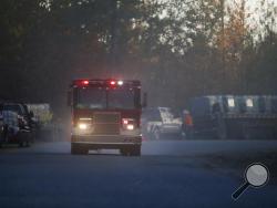 A fire truck drives on River Road near the scene of an explosion of a Colonial Pipeline, Monday, Oct. 31, 2016, in Helena, Ala. Colonial Pipeline said in a statement that it has shut down its main pipeline in Alabama after the explosion in a rural part of the state outside Birmingham. (AP Photo/Brynn Anderson)