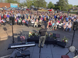 A pastor prays for shooting victims in Dadeville, Ala., at a vigil in the parking lot of First Baptist Church, Sunday, April 16, 2023. (AP Photo/Jeff Amy)
