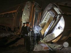 In this May 12, 2015 file photo, emergency personnel work the scene of a train wreck (AP Photo/Joseph Kaczmarek, File)