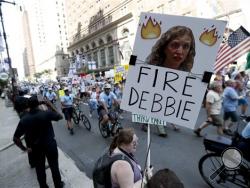 A supporters of Sen. Bernie Sanders, I-Vt., holds up a sign call calling for Debbie Wasserman Schultz, chairwoman of the Democratic National Committee to be fired, Sunday, July 24, 2016, in Philadelphia. The Democratic National Convention starts Monday. (AP Photo/Alex Brandon)