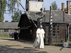 Pope Francis walks through the gate of the former Nazi German death camp of Auschwitz in Oswiecim, Poland, Friday, July 29, 2016. (AP Photo/Gregorio Borgia)