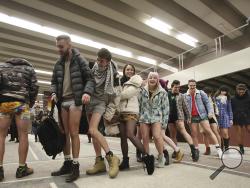 Young people in Warsaw, Poland, wait to ride on the subway with no pants on as they join a global event Sunday, Jan. 8, 2017, amid freezing winter weather outside. (AP Photo/Czarek Sokolowski)