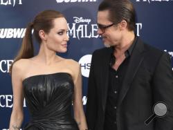 FILE - In this May 28, 2014 file photo, Angelina Jolie and Brad Pitt arrive at the world premiere of "Maleficent" in Los Angeles. Angelina Jolie Pitt and Brad Pitt have reached an agreement to handle their divorce in a private forum and will work together to reunify their family, the actors announced in a joint statement Monday, Jan. 9, 2017. (Photo by Matt Sayles/Invision/AP, File)