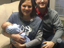 In the photo taken Dec. 24, 2016, by Luke Gardner with his cell phone on a timer, Luke and Hillary Gardner pose with their son Cade Lee in Baldwyn, Miss. The husband and wife share the same birthday, and now also their son who was born on Dec. 18. The odds of that happening are about one in 133,000 statisticians say. (Luke Gardner via AP)