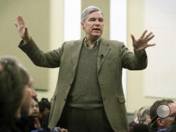 In this Jan. 29, 2017, photo, Sen. Sheldon Whitehouse, D-R.I., tries to calm the audience after shouting matches erupted during his community meeting at Nathan Bishop School in Providence, R.I. Protesters shouted down Whitehouse during the community event as they protested his vote in favor of President Donald Trump's nominee for CIA director. National Democrats are racing to respond to the wave of liberal outrage unleashed by President Donald Trump, jumping into protests, organizing rallies and vowing to b