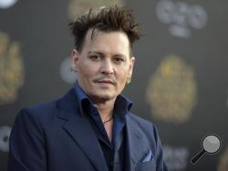 FILE - In this May 23, 2016 file photo, Johnny Depp arrives at the premiere of "Alice Through the Looking Glass" at the El Capitan Theatre, in Los Angeles. Depp's former business managers countersued the actor on Tuesday, Jan. 31, 2017, stating that they frequently advised him that his spending was out of control. Depp sued his former business managers earlier this month alleging they mismanaged his money. (Photo by Richard Shotwell/Invision/AP, File)