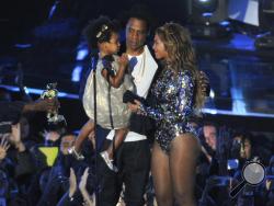 FILE - This Aug 24, 2014 file photo shows Beyonce on stage with Jay Z and their daughter Blue Ivy as she accepts the Video Vanguard Award at the MTV Video Music Awards in Inglewood, Calif. Beyonce announced on her Instagram account, Wednesday, Feb. 1, 2017, that she is expecting twins. (Photo by Chris Pizzello/Invision/AP, File)