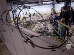 In this Jan. 31, 2017 photo visitors to the miniature wonderland in Hamburg , Germany, can only look at a model landscape of the United States from behind a wall . (Christian Charisius/dpa via AP)