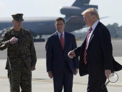  In this Monday, Feb. 6, 2017, file photo, President Donald Trump passes Joint Chiefs Chairman Gen. Joseph Dunford, left, and National Security Adviser Michael Flynn as he arrives via Air Force One at MacDill Air Force Base in Tampa, Fla. A top White House aide sidestepped repeated chances Sunday, Feb. 12, to publicly defend Flynn following reports that he engaged in conversations with a Russian diplomat about U.S. sanctions before Trump's inauguration. (AP Photo/Susan Walsh, File)