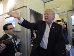 President Donald Trump talks to reporters on board Air Force One as he arrived to speak at his "Make America Great Again Rally" at Orlando-Melbourne International Airport in Melbourne, Fla., Saturday, Feb. 18, 2017. (AP Photo/Susan Walsh)