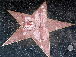 FILE - This Oct. 26, 2016 file photo shows the vandalized Hollywood Walk of Fame star of then-presidential candidate Donald Trump. An attorney for James Lambert Otis, who admitted causing the damage, says he pleaded no contest to felony vandalism Tuesday, Feb. 21, 2017. He was sentenced to three years of probation, 20 days of community labor and to pay $4,400 for the damage. (AP Photo/Richard Vogel, File)