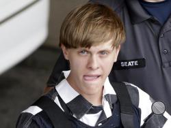 FILE - In this June 18, 2015 file photo, Charleston, S.C., shooting suspect Dylann Storm Roof is escorted from the Cleveland County Courthouse in Shelby, N.C. In court documents unsealed Tuesday, Feb. 21, 2017, Roof, convicted of killing nine worshippers during Bible study at a black church drove toward a second black church after the shootings, according to South Carolina prosecutors who oversaw the federal case against him. (AP Photo/Chuck Burton, File)