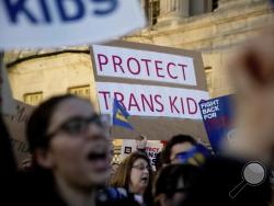 Activists and protesters with the National Center for Transgender Equality rally in front of the White House, Wednesday, Feb. 22, 2017, in Washington, after the Department of Education and the Justice Department announce plans to overturn the school guidance on protecting transgender students. (AP Photo/Andrew Harnik)