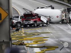 A tanker truck carrying propane lays overturned Monday, Feb. 27, 2017, in Seattle. The semi-truck rolled on a southbound lane that feeds into Interstate 5 on Monday. (Grant Hindsley/seattlepi.com via AP)