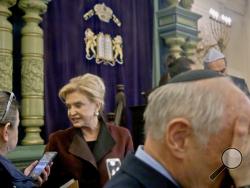 Congresswoman Carolyn Maloney, center, member of Congress's bipartisan task force combating anti-Semitism, speaks with a reporter after holding a press conference to address bomb treats against Jewish organizations and vandalism at Jewish cemeteries, Friday March 3, 2017, at the Park East Synagogue in New York. (AP Photo/Bebeto Matthews)