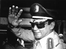  FILE - In this Aug. 31, 1989 file photo, Gen. Manuel Antonio Noriega waves to newsmen after a state council meeting, at the presidential palace in Panama City, where they announced the new president of the republic. Panama's ex-dictator Noriega died Monday, May 29, 2017, in a hospital in Panama City. He was 83. (AP Photo/Matias Recart, File)
