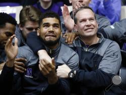 Northwestern coach Chris Collins, right, and guard/forward Sanjay Lumpkin react while watching television coverage of the NCAA men's basketball tournament selection show, Sunday, March 12, 2017 at Welsh-Ryan Arena in Evanston, Ill. Northwestern, in its first tournament appearance, will play Vanderbilt. (AP Photo/Nam Y. Huh)