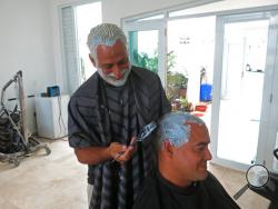 Civil engineer Christian Rodriguez, standing, and hair stylist Yoniel Padro dye each other's hair blond in support of Puerto Rico's baseball team in San Juan, Puerto Rico, Tuesday, March 21, 2017. Pharmacies and beauty stores across Puerto Rico are running out of hair dye as a growing number of men go blond in support of the island's baseball players who bleached their hair as a bonding ritual ahead of the World Baseball Classic. (AP Photo/Danica Coto)