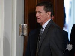 FILE - In this Feb. 13, 2017 file photo, Mike Flynn arrives for a news conference in the East Room of the White House in Washington. Flynn’s attorney says the former national security adviser is in discussions with the House and Senate intelligence committees on receiving immunity from “unfair prosecution” in exchange for questioning. Flynn attorney Robert Kelner says no “reasonable person” with legal counsel would answer questions without assurances. (AP Photo/Evan Vucci, File)