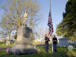 United State Marine Corp Staff Sgt. Kevin Harmon, left, and Pfc. David Aguirre raise the flag at Mount Mora Cemetery Thursday, April 6, 2017, in St. Joseph, Mo. They also laid a wreath at the World War I memorial in honor of the 100th anniversary of the United States entering the first world war. (Jessica A. Stewart/The St. Joseph News-Press via AP)