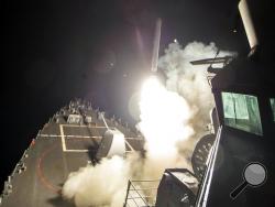 In this image provided by the U.S. Navy, the USS Ross (DDG 71) fires a tomahawk land attack missile Friday, April 7, 2017, from the Mediterranean Sea. The United States blasted a Syrian air base with a barrage of cruise missiles in fiery retaliation for this week's gruesome chemical weapons attack against civilians. (Mass Communication Specialist 3rd Class Robert S. Price/U.S. Navy via AP)