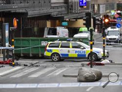 A concrete traffic stopper called "Stockholmslejon" lays on its side outside the cordoned off area next to the department store Ahlens following a suspected terror attack on the Drottninggatan Street in central Stockholm, Sweden, Saturday April 8, 2017. A hijacked beer truck plowed into pedestrians at a central Stockholm department store on Friday, killing several people, wounding many others and sending screaming shoppers fleeing in panic in what Sweden's prime minister called a terrorist attack. A nationw