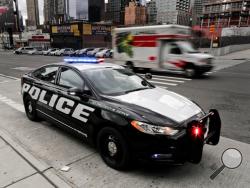 In this Friday, April 7, 2017, photo, a prototype of the Ford Fusion police hybrid car sits along 11th Avenue in New York. Ford Motor Co., which sells more police cars in the U.S. than any other automaker, says it will offer a police pursuit version of the hybrid Fusion midsize sedan, in response to requests from cities nationwide. (AP Photo/Julie Jacobson)