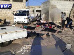 FILE - In his photo April 4, 2017 file photo, provided by the Syrian anti-government activist group Edlib Media Center, which has been authenticated based on its contents and other AP reporting, shows victims of a suspected chemical attack, in the town of Khan Sheikhoun, northern Idlib province, Syria. A senior U.S. official says the U.S. has concluded that Russia knew in advance of Syria’s chemical weapons attack last week. (Edlib Media Center, via AP)