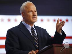 FILE - In this Tuesday, Oct. 4, 2016 file photo, U.S. Congressman Mike Coffman, R-Colo., makes a point during a debate with his opponent for Colorado's 6th Congressional District seat, Democrat Morgan Carroll, at a Spanish language television station in Denver. Coffman, one of the few swing district Republican representatives in the country, will be holding a town hall meeting with constituents on Wednesday, April 12, 2017. (AP Photo/David Zalubowski, file)