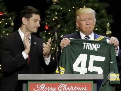  In this Dec. 13, 2016, file photo, President-elect Donald Trump holds up Green Bay Packers jersey given to him by House Speaker Paul Ryan at a rally in West Allis, Wis. President Donald Trump heads to Ryan's congressional district in Wisconsin on Tuesday, April 18, 2017, facing low approval ratings and in the wake of his failure to fulfill a campaign promise to repeal and replace the federal health care law. (AP Photo/Morry Gash, File)