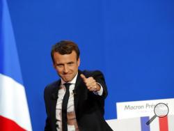 French centrist presidential candidate Emmanuel Macron thumbs up as he addresses his supporters at his election day headquarters in Paris , Sunday April 23, 2017. Macron and far-right populist Marine Le Pen advanced Sunday to a runoff in France's presidential election, remaking the country's political system and setting up a showdown over its participation in the European Union. (AP Photo/Christophe Ena)