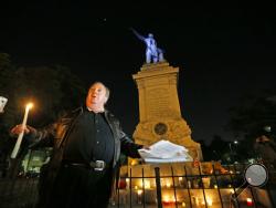 Charles Lincoln speaks during a candlelight vigil at the statue of Jefferson Davis in New Orleans, Monday, April 24, 2017. New Orleans will begin taking down Confederate statutes, becoming the latest Southern body to divorce itself from what some say are symbols of racism and intolerance. (AP Photo/Gerald Herbert)