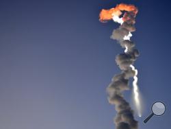  FILE - In this Sept. 27, 2011 file photo, a Minotaur IV rocket takes off from Kodiak Launch Complex on Kodiak Island, Alaska. The rocket was carrying an experimental Navy satellite designed to provide safer combat communications. Today, Alaska Aerospace has rebuilt its launch site after a rocket exploded after takeoff in 2014 and is again showing signs of liftoff. (James Brooks/Kodiak Daily Mirror via AP, File)