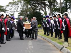 FILE - In this June 4, 2016, photo, the Knights of Columbus, Yerba Buena Lodge of San Francisco, stand guard as the casket, holding the body of a girl found in May 2016 and buried in San Francisco, is carried to her new grave at Greenlawn Memorial Park Cemetery in Colma, Calif. The girl who died in 1876 and was found last year inside a small metal casket under a San Francisco home has been identified. The nonprofit Garden of Innocence project said Tuesday, May 9, 2017, that the child was 2-year-old Edith Ho