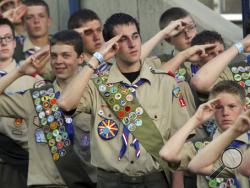 In this July 3, 2010, photo, Boy Scouts salute during the Stadium of Fire in Provo, Utah. The Mormon church, the biggest sponsor of Boy Scout troops in the United States, announced Thursday, May 11, 2017, it is pulling as many as 185,000 older youths from the organization as part of an effort to start its own scouting-like program. (Rick Egan/The Salt Lake Tribune via AP)