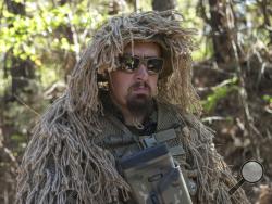  Chad Carroll wears a ghillie suit in the woods of Jackson, Georgia, on April 1, 2017, during training exercises with the militia, Georgia Security Force. Armed militias in the United States, still wary of perceived threats, foreign and domestic, aren't ready to lay down their arms under President Donald Trump. (AP Photo/Lisa Marie Pane)