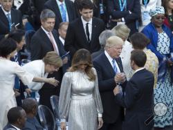  President Donald Trump, accompanied by first lady Melania Trump greets French President Emmanuel Macron and Brigitte Macron before a concert by the La Scala Philharmonic Orchestra at the Ancient Greek Theatre of Taormina, Sicily, Friday, May 26, 2017. German Chancellor Angela Merkel is second from left, Canadian Prime Minister Justin Trudeau is at center. (Stephen Crowley/The New York Times via AP, Pool)