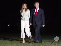  President Donald Trump and first lady Melania Trump walk from Marine One across the South Lawn to the White House in Washington, Saturday, May 27, 2017, as they return from Sigonella, Italy. (AP Photo/Carolyn Kaster)