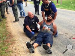  Officers arrest suspect Willie Corey Godbolt on Sunday, May 28, 2017, following several fatal shootings Saturday in Lincoln County, Miss., officials said. (Therese Apel/The Clarion-Ledger via AP)