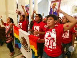  Demonstrators march in the Texas Capitol on Monday, May 29, 2017, protesting the state's newly passed anti-sanctuary cities bill in Austin, Texas. Opponents call Texas' anti-sanctuary cities law a "show your papers" law since it empowers police to inquire about peoples' immigration status during routine interactions such as traffic stops. (AP Photo/Meredith Hoffman)